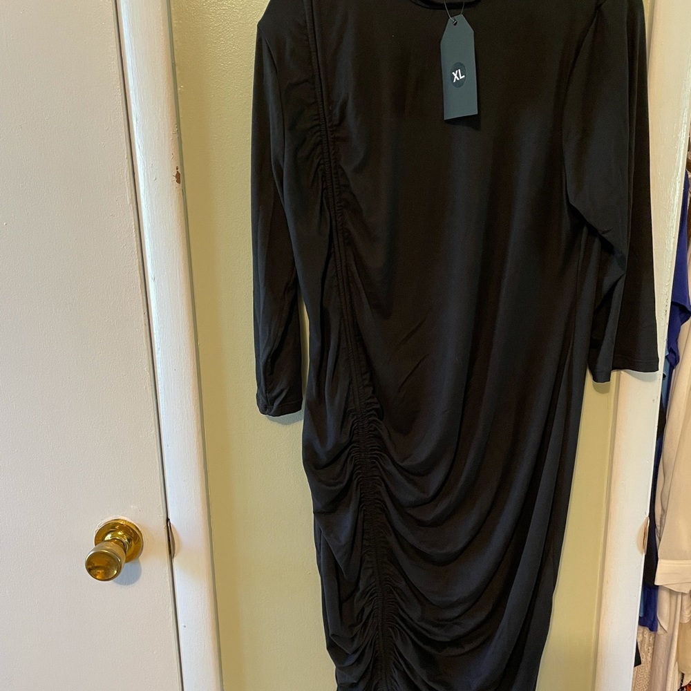Never worn. New with tag black dress. Size 1X.